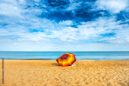 Umbrella on golden sand beach