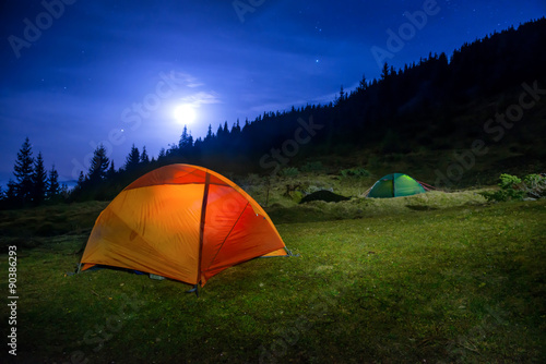 Two Illuminated orange and green camping tents