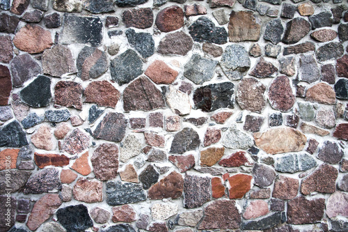 Background of stone wall texture photo. old path paved with cobblestones colorful