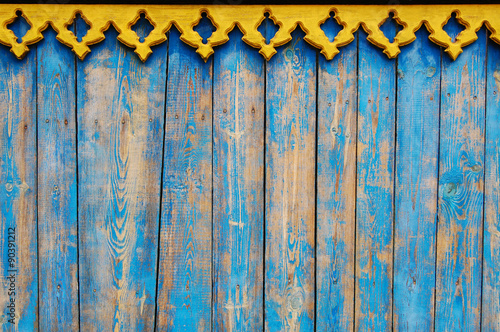 Slika na platnu Blue wooden background with yellow bordering