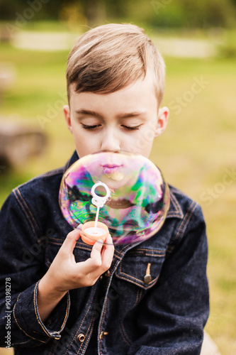 Child and big soap bubble