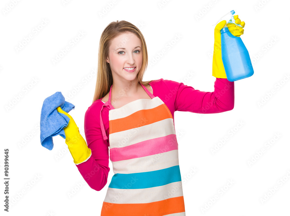 Housewife cleaning with rag and bottle spray