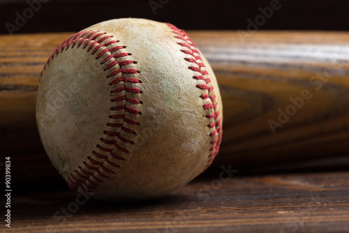 Canvas Print A wooden baseball bat and ball on a wooden background