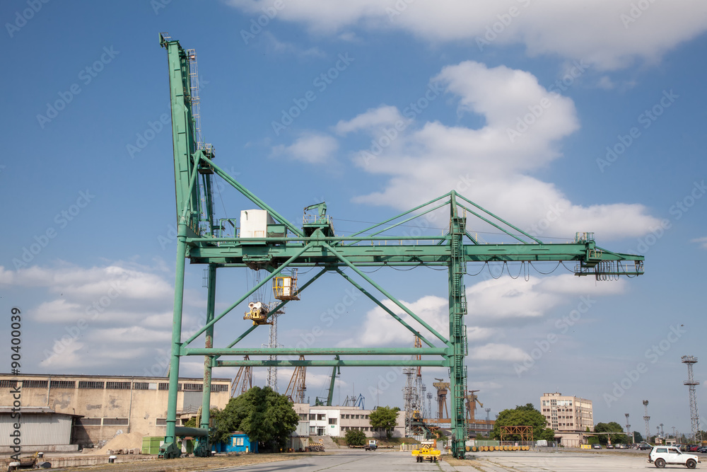 Container crane in Industrial Port. Cloudy sky