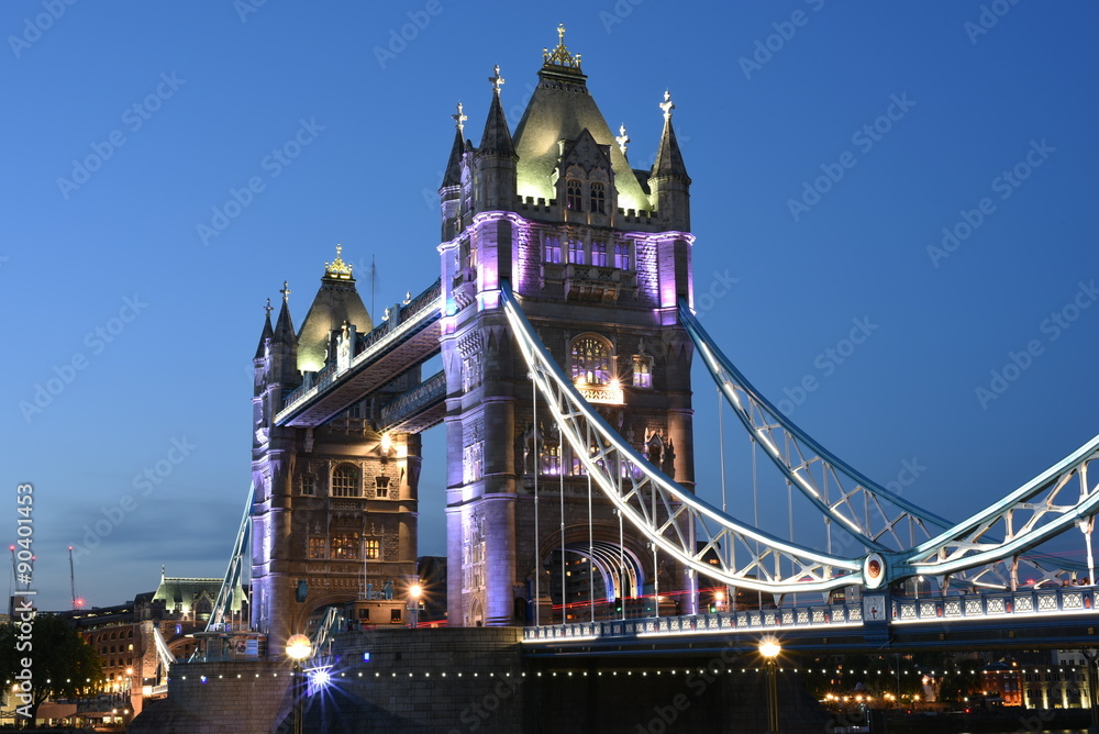 Obraz premium World famous Historic Tower Bridge in London, UK at night with light trail of red bus, long exposure artistic shot