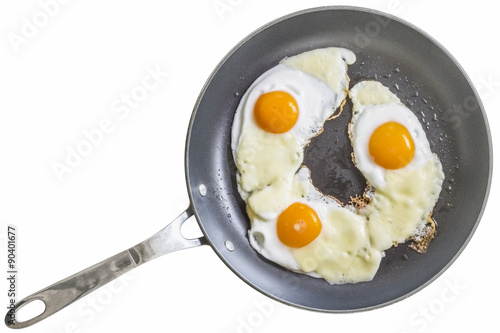 Three Sunny Side Up Fried Eggs, With Edam Cheese Slices, in Teflon Frying Pan, Isolated on White Background.