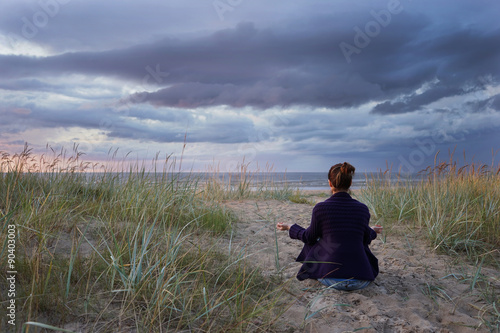 Woman meditate at the sea