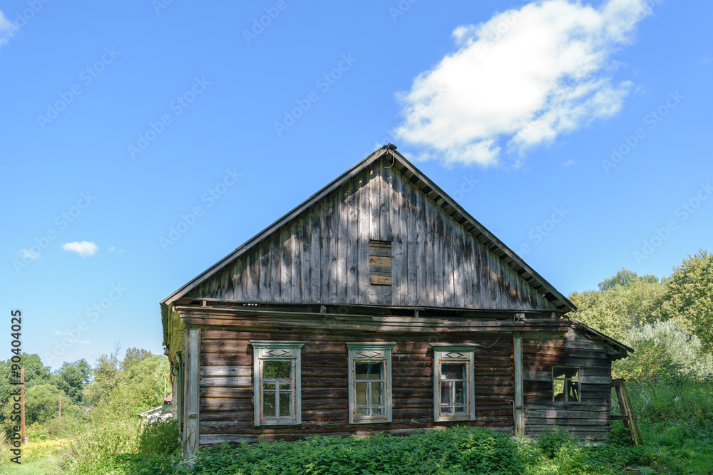 Old dilapidated abandoned wooden house on forest clearing Old dilapidated abandoned wooden house on forest clearing