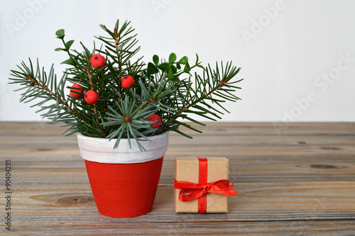 Christmas arrangement and Christmas gift on wooden background
