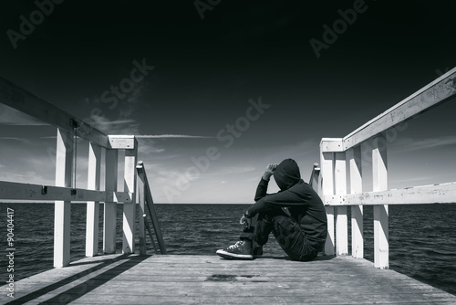 Canvas Print Alone Man at the Edge of Wooden Pier