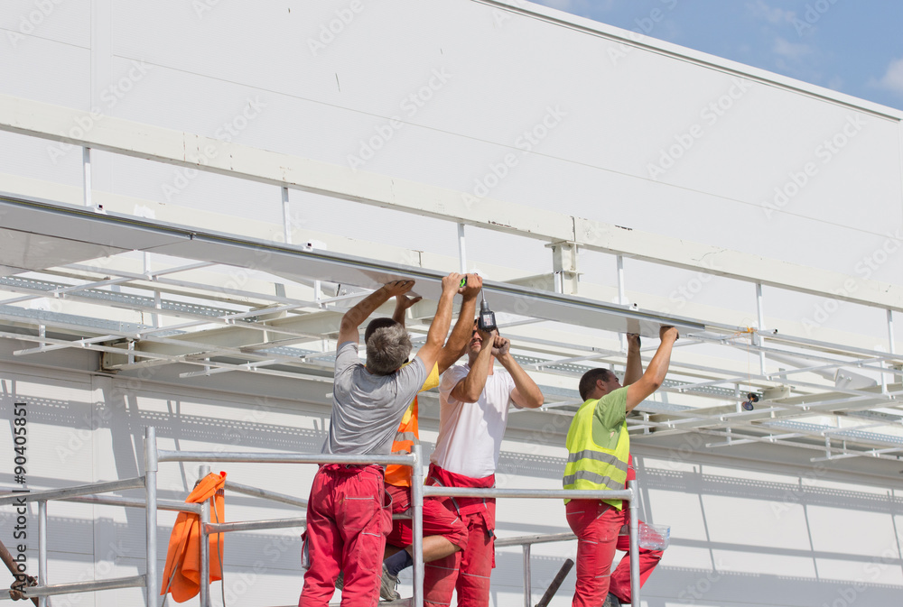 Workers installing awnings Workers installing awnings
