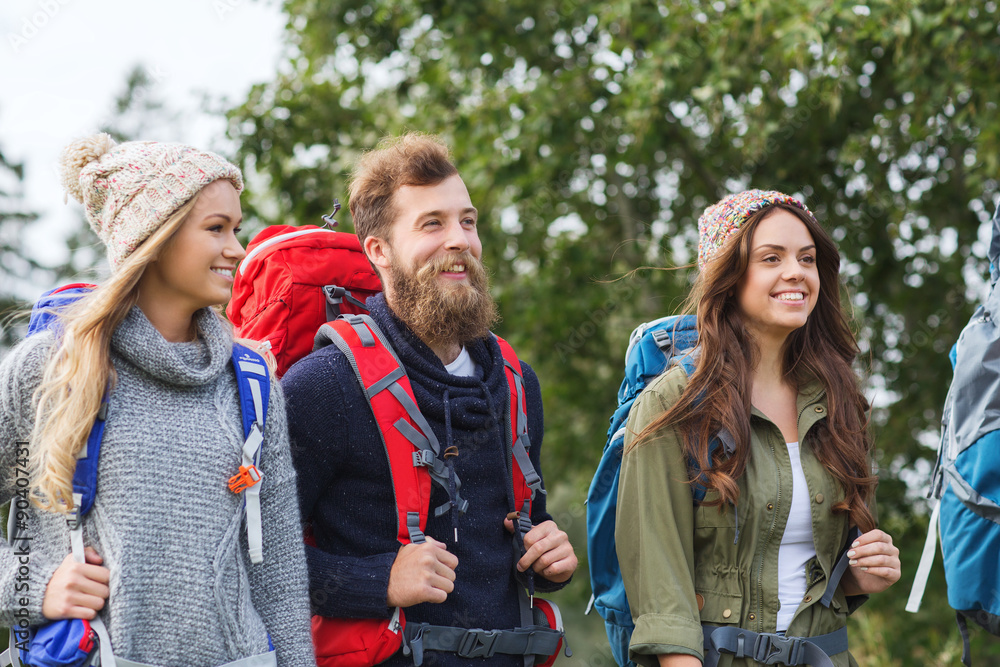 group of smiling friends with backpacks hiking group of smiling friends with backpacks hiking