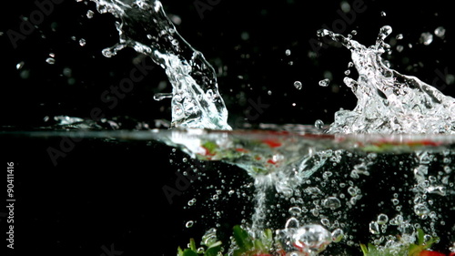 Wallpaper Mural Strawberries falling in water on black background Torontodigital.ca