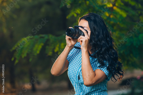 young woman photographer taking photo outdoor