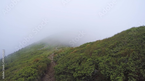 Strong wind drives the cloud on the top of Mountain. Chornohora Range in the Carpathians, Ukraine.  August 2015. The clouds are born and are disperse. 4K photo