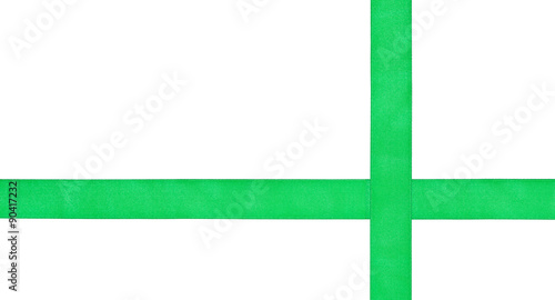 Fotografie two crossing green satin tapes isolated