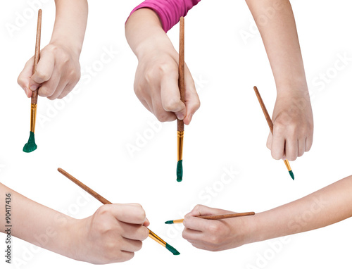 set of hands with art paintbrushes with green tips