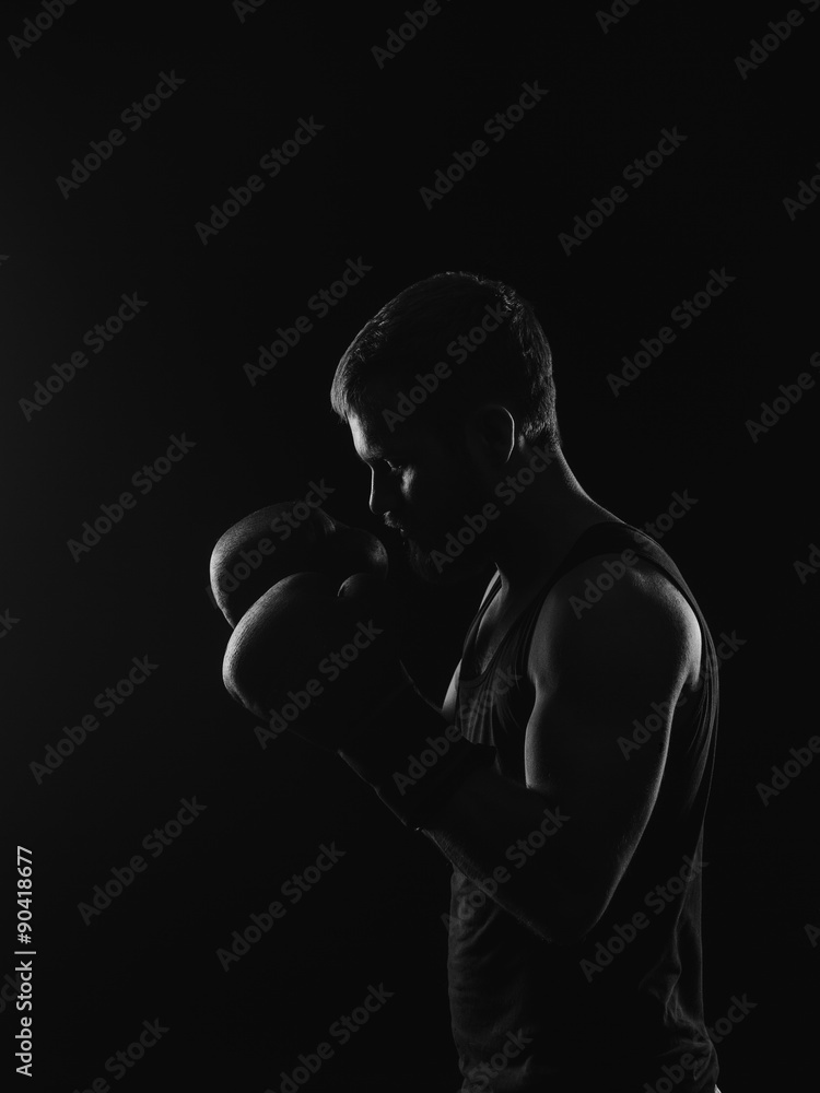 Athletic bearded boxer with gloves on a dark background Athletic bearded boxer with gloves on a dark background