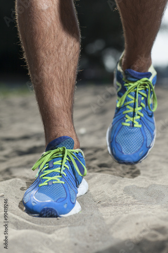 running shoes close up in sand