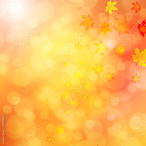 Colorful autumn leaves on blurred bright yellow red bokeh background. Autumn season illustration with copyspace background.