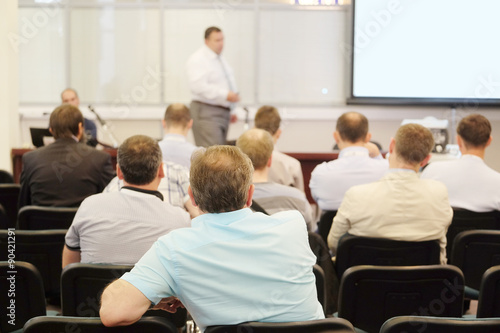 The audience listens to the acting in a conference hall