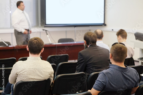 The audience listens to the acting in a conference hall