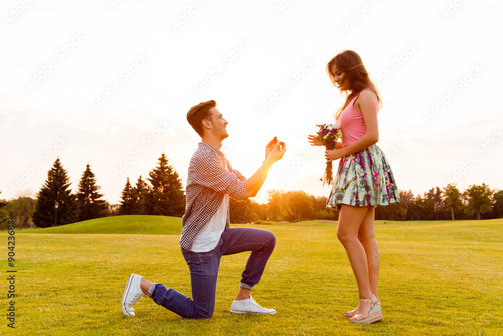 Fototapeta premium young man makes a proposal of betrothal to his girlfriend