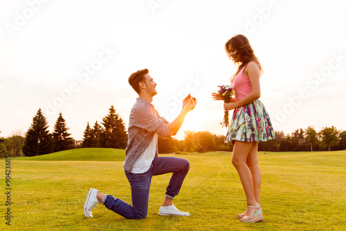 young man makes a proposal of betrothal to his girlfriend