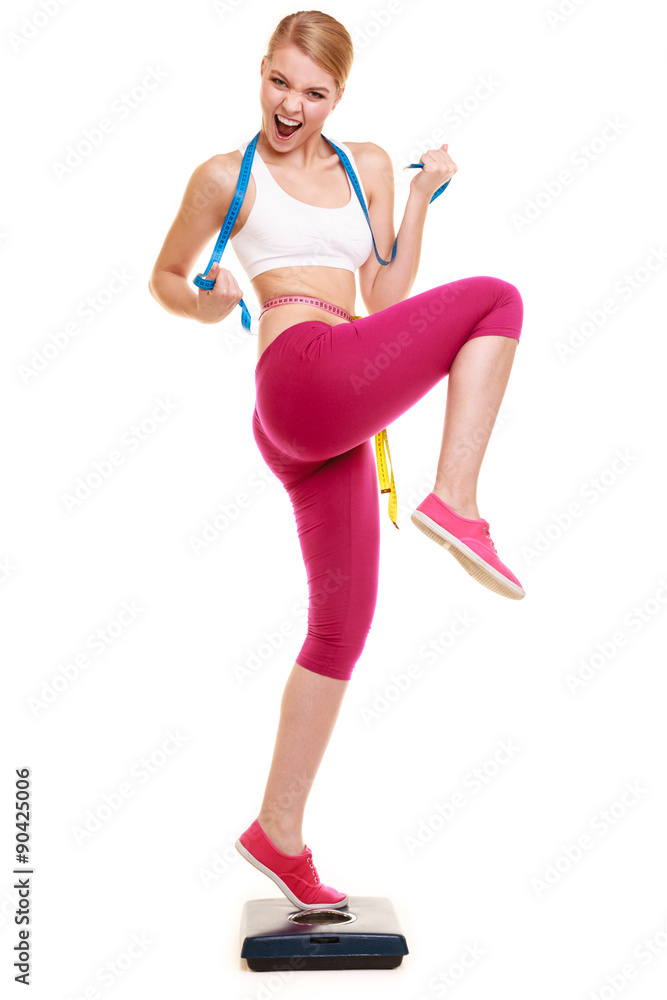 Woman clenching fists measuring on weighing scale. Woman clenching fists measuring on weighing scale.