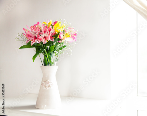 Alstroemeria flowers in vase on table