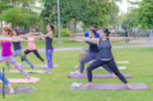 blurred woman fitness group - yoga team.