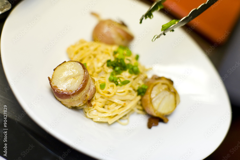 Bacon wrapped scallops and Fettuccine with tongs