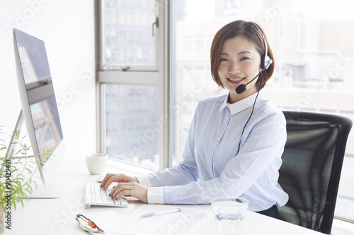 Women smiling and wearing a headset