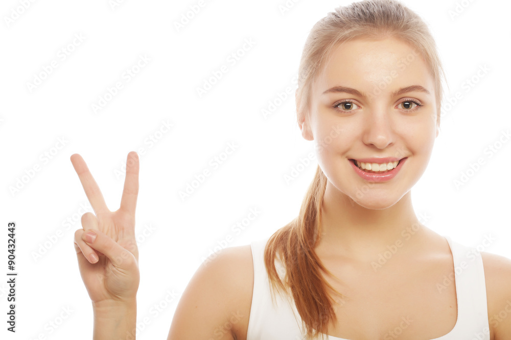 portrait of happy young woman giving peace sign portrait of happy young woman giving peace sign