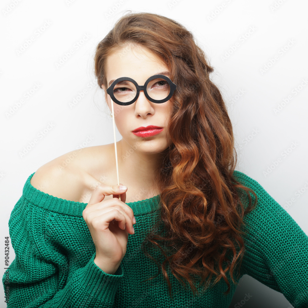 Party image. Playful young women holding a party glasses.