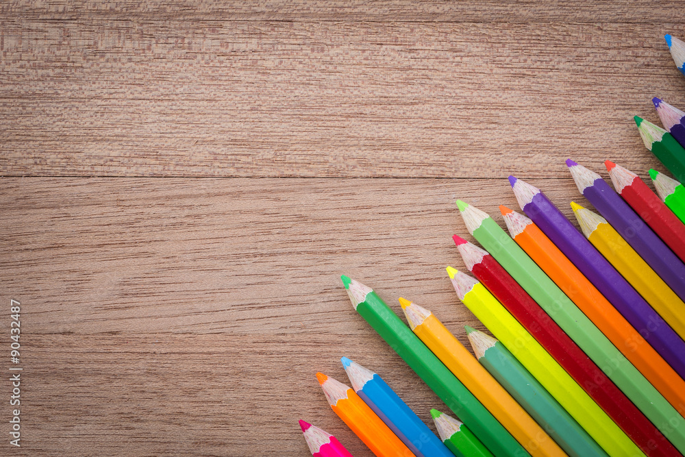 Stack colour pencils on wooden background Stack colour pencils on wooden background