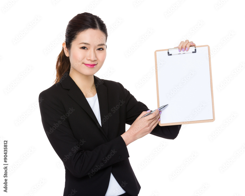 Young businesswoman with pen point to clipboard Young businesswoman with pen point to clipboard