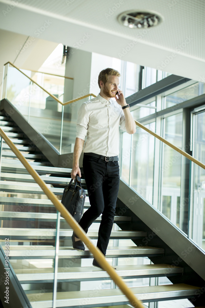 Young businessman on the stairs Young businessman on the stairs
