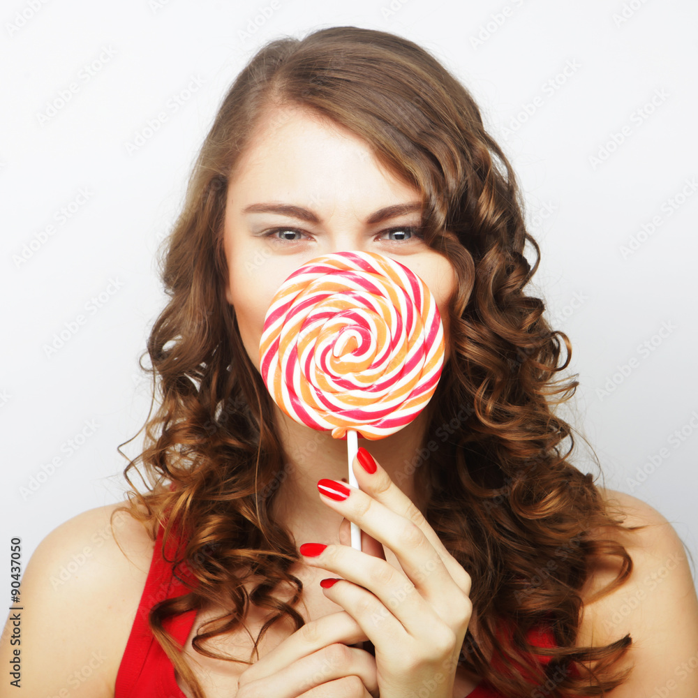Young sexual woman holding lollipop. 