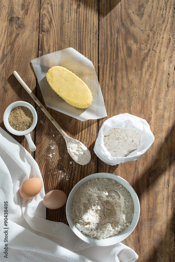 top view, ingredients to make a cake on a wooden table top view, ingredients to make a cake on a wooden table