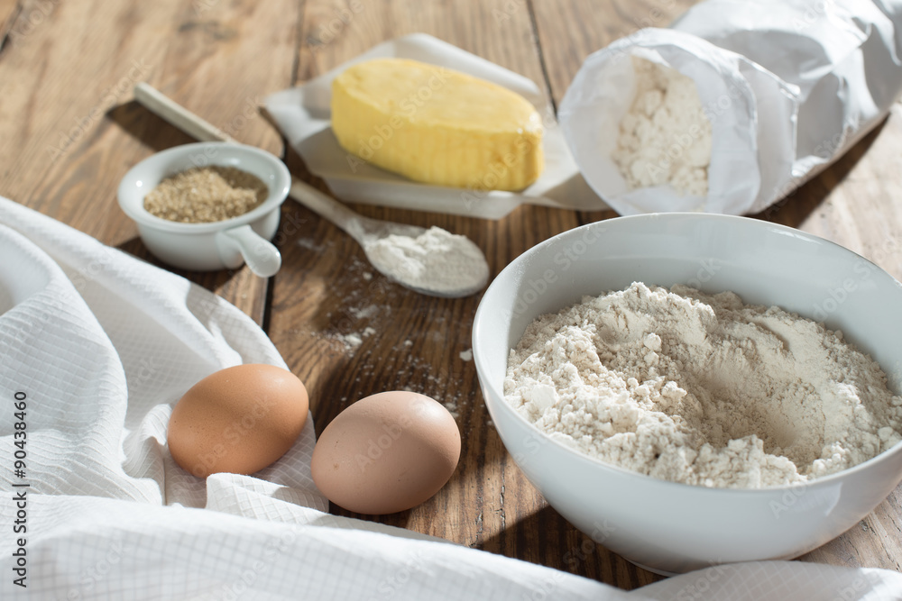 ingredients to make a cake on a wooden table ingredients to make a cake on a wooden table