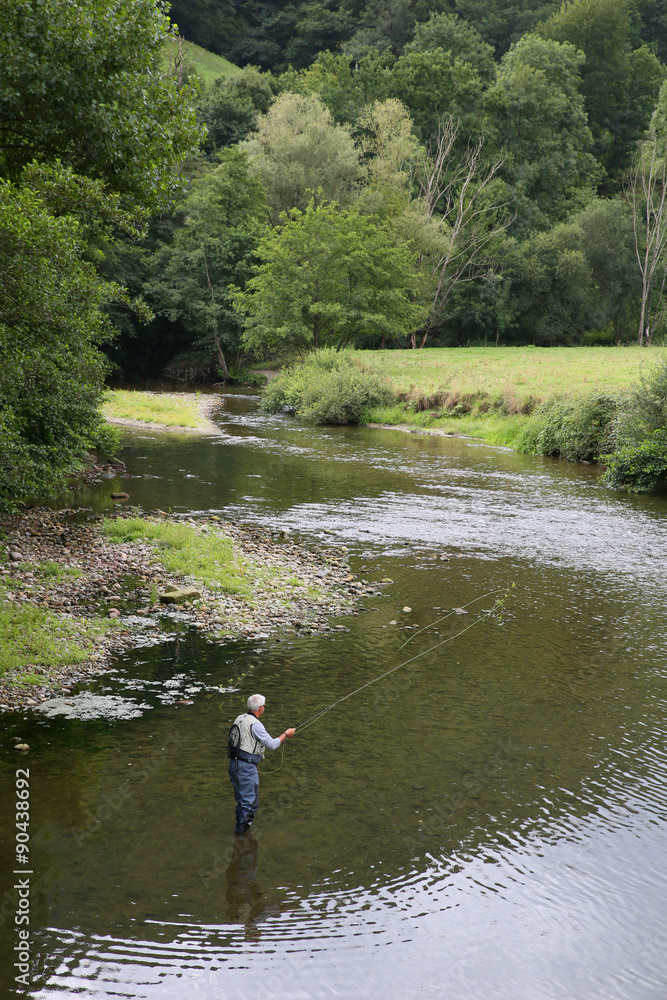 Upper view of fly-fisherman fishing in river