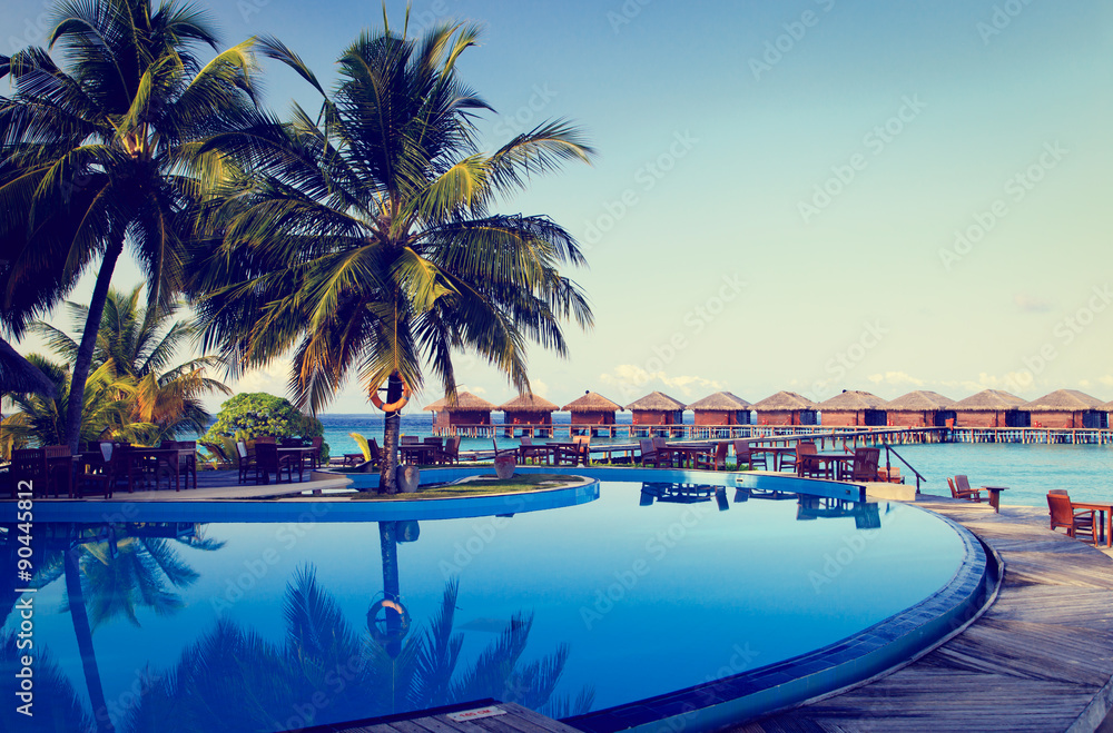 Tropical resort swimming pool and cafe bar - obrazy, fototapety, plakaty 