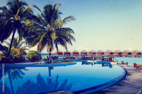 Fototapeta Tropical resort swimming pool and cafe bar