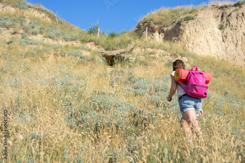 a woman climbs the hill