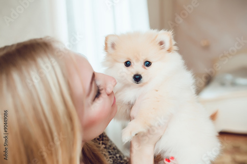 Beautiful Blonde Woman with Her Dog in a Beautiful Interior