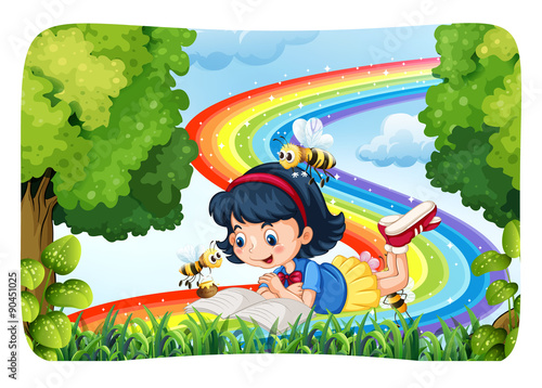 Girl reading in nature with rainbow