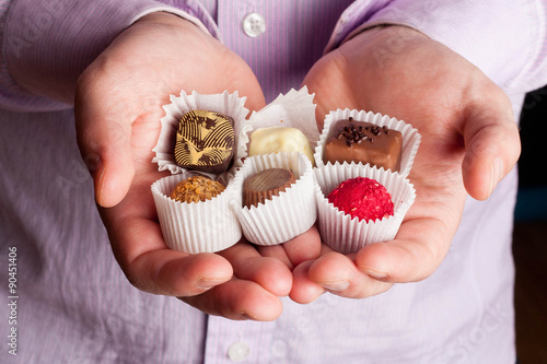 Beautiful chocolate candy in mens palms