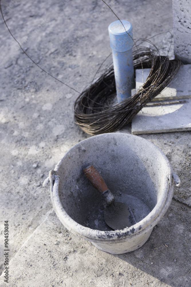 Cement bucket and blue pvc pipe at construction site Cement bucket and blue pvc pipe at construction site
