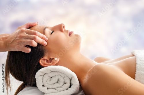 Woman having relaxing facial massage. #90453094